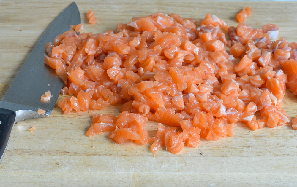 chopping salmon to make salmon cakes