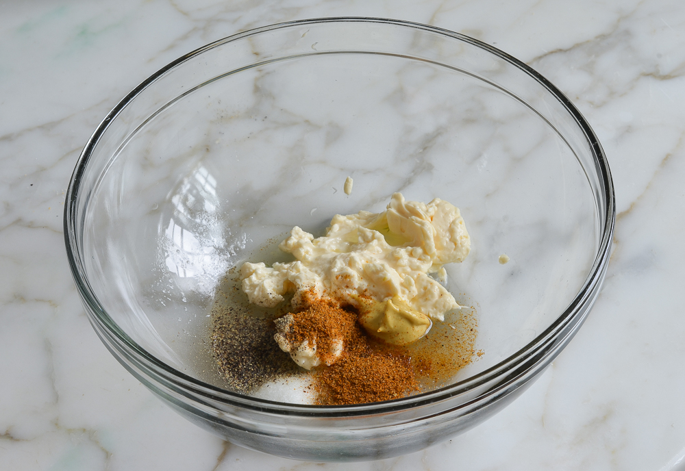 mayonnaise and seasoning in bowl for making salmon cakes