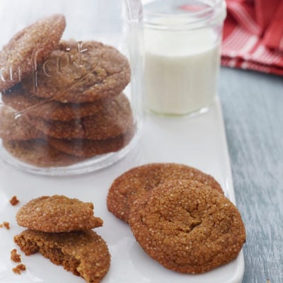 Molasses cookies in a jar and on a board.