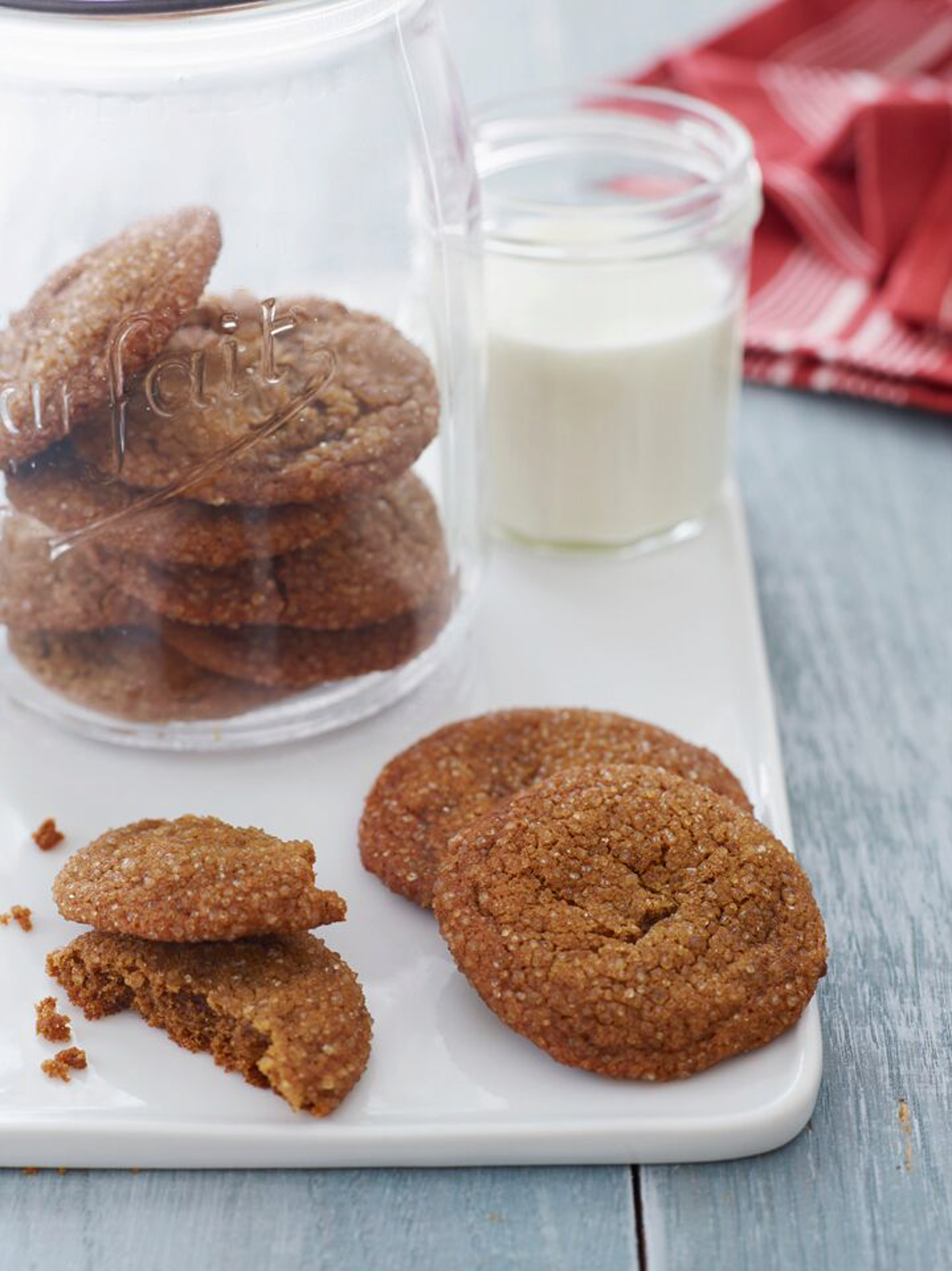 Molasses cookies in a jar and on a board.