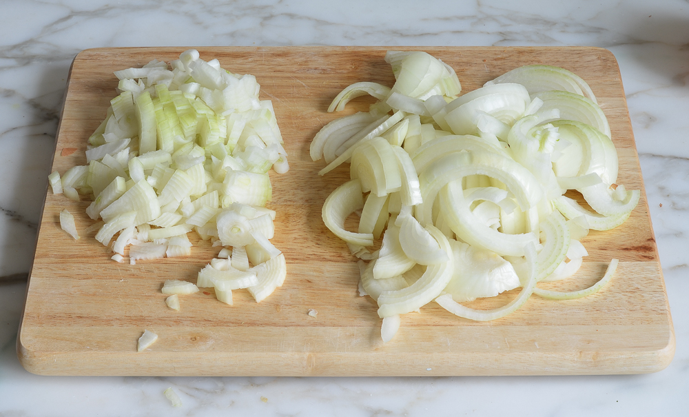 Cutting board with sliced and diced onions.
