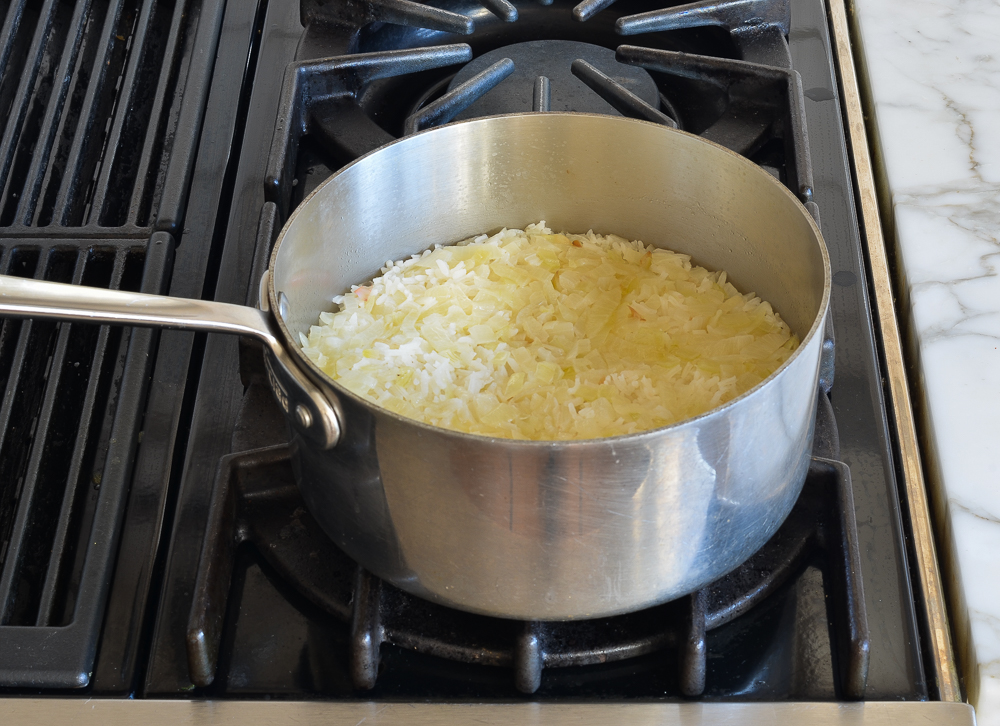 Sauce pan of rice and onions.