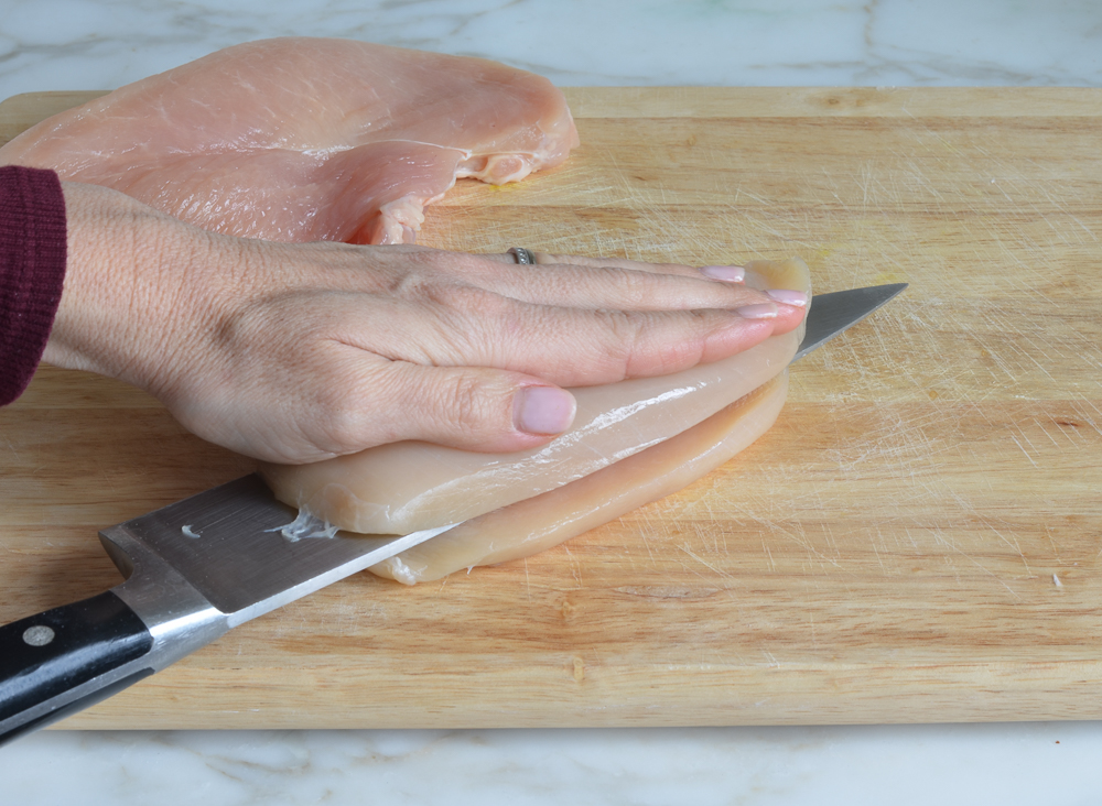 slicing the chicken breasts in half horizontally