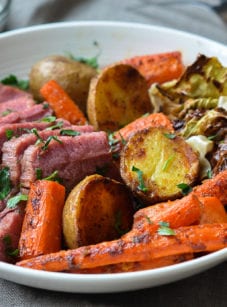 corned beef and cabbage in bowl with horseradish cream sauce on side