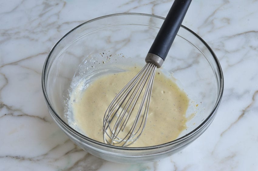 whisked dressing in mixing bowl