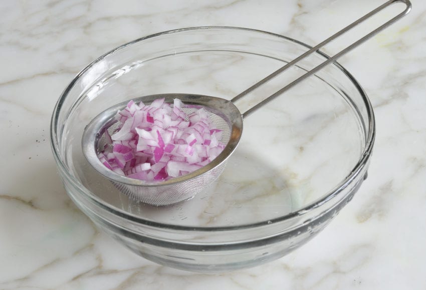 Red onion in a sieve.