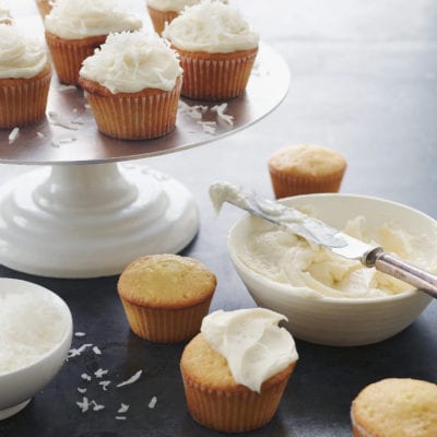 Coconut Cupcakes on a cake platter.