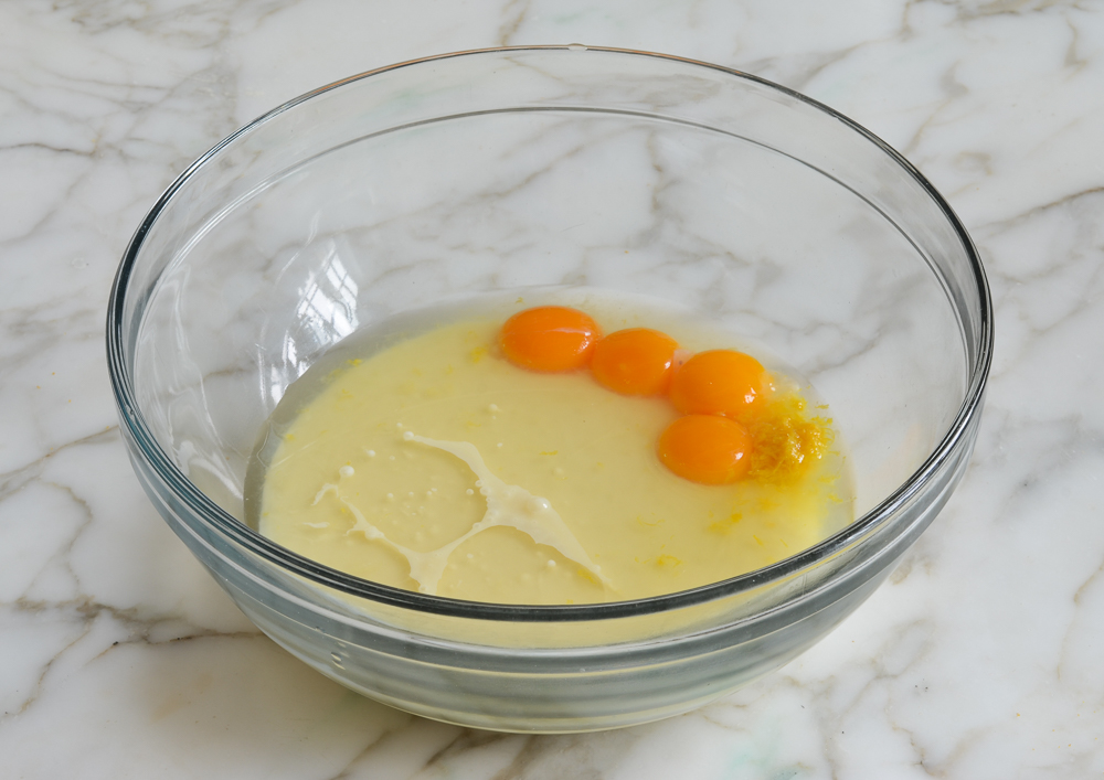 Egg yolks, sweetened condensed milk, and lemon in a bowl.