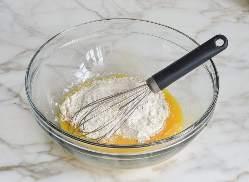 Flour and eggs in a bowl.