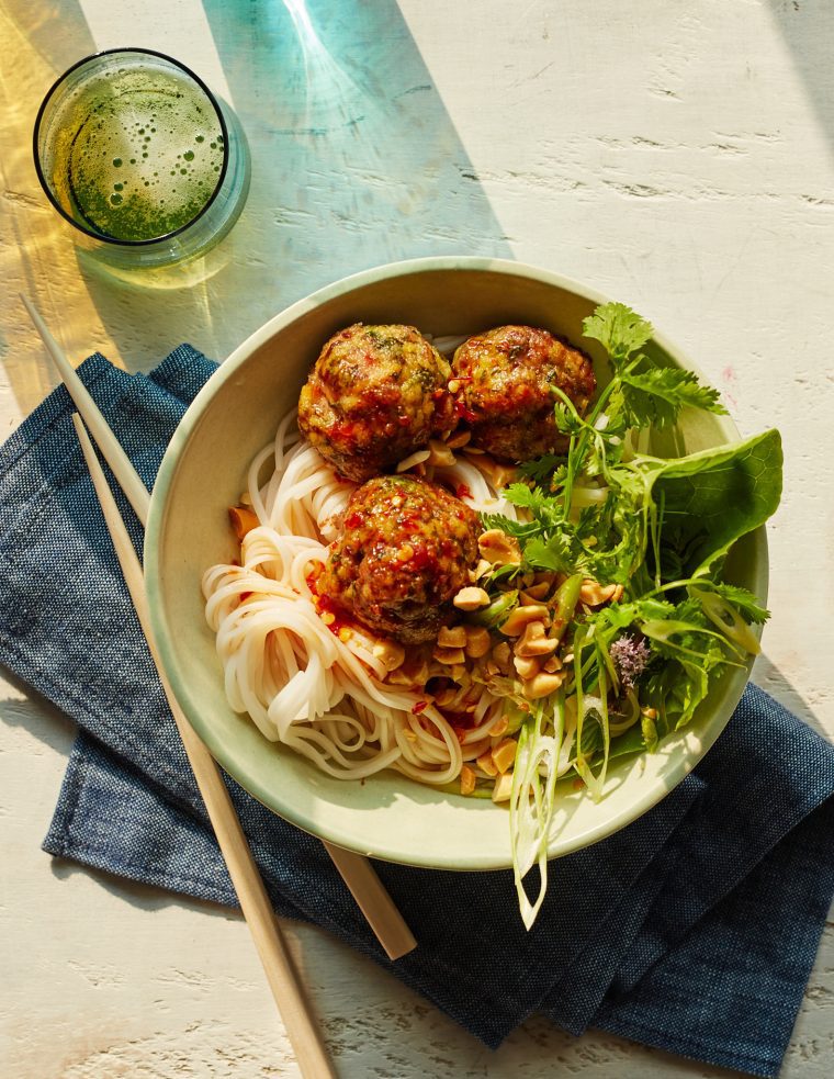 Vietnamese-style meatballs with chili sauce in a bowl over noodles.