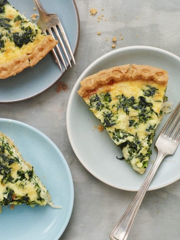 Slices of Spinach Quiche on plates.