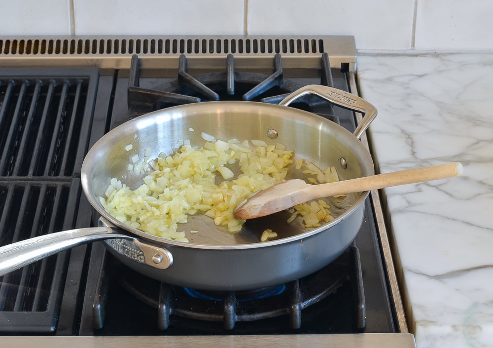 Onions cooking in a skillet.