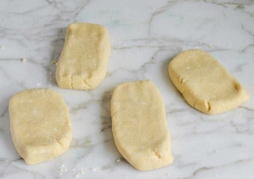 Four flattened pieces of dough.