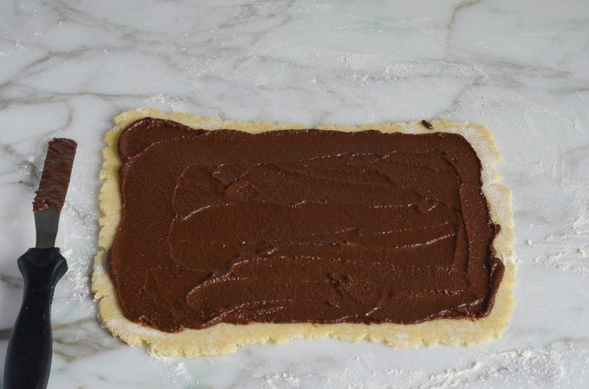 Chocolate spread onto dough.