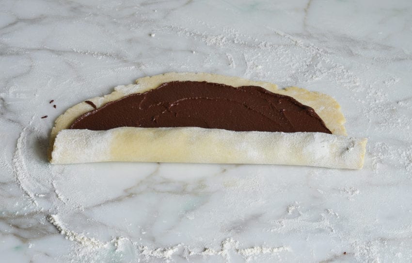 Dough with chocolate that is half-rolled into a cylinder.