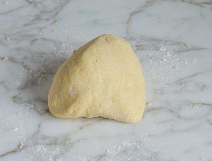 Ball of dough on a countertop.