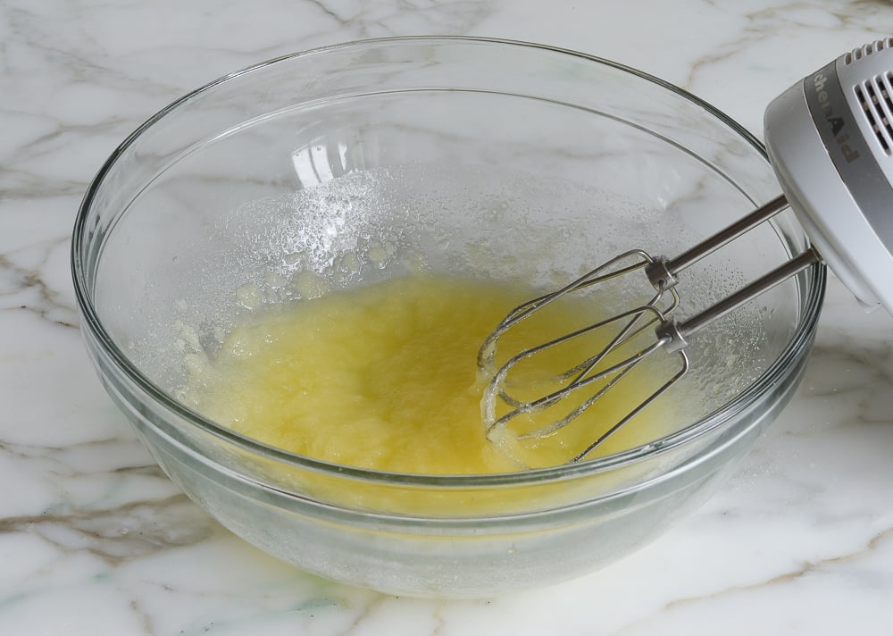 Electric mixer with a bowl of butter and sugar.