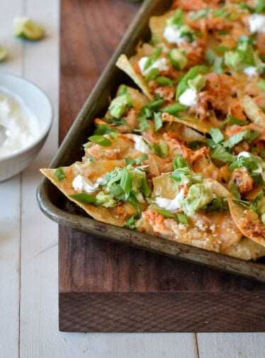 Chicken nachos on a baking sheet.