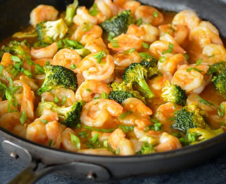 Skillet of sweet and sour shrimp with broccoli.