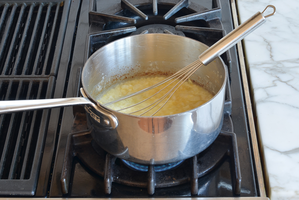 Whisk in a sauce pan with an onion mixture.