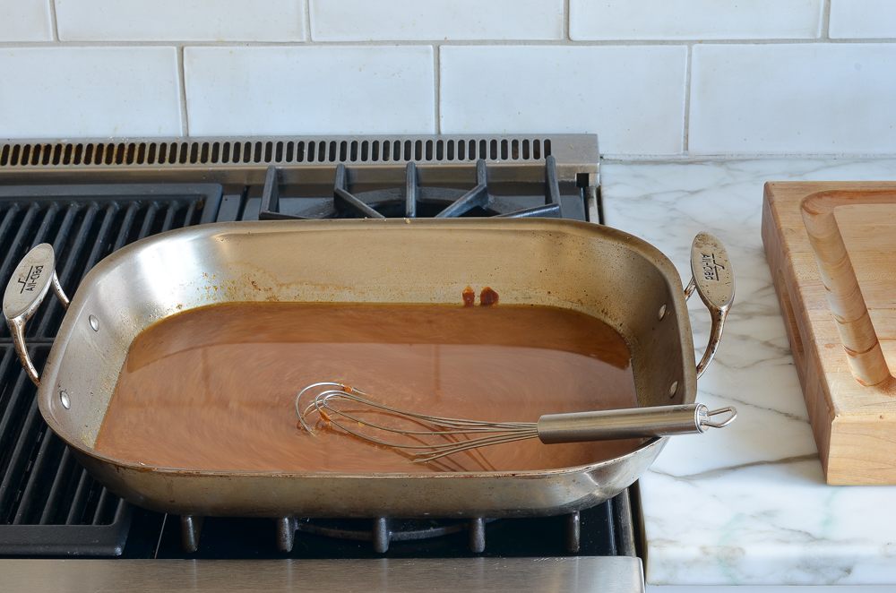 Roasting pan filled with broth.