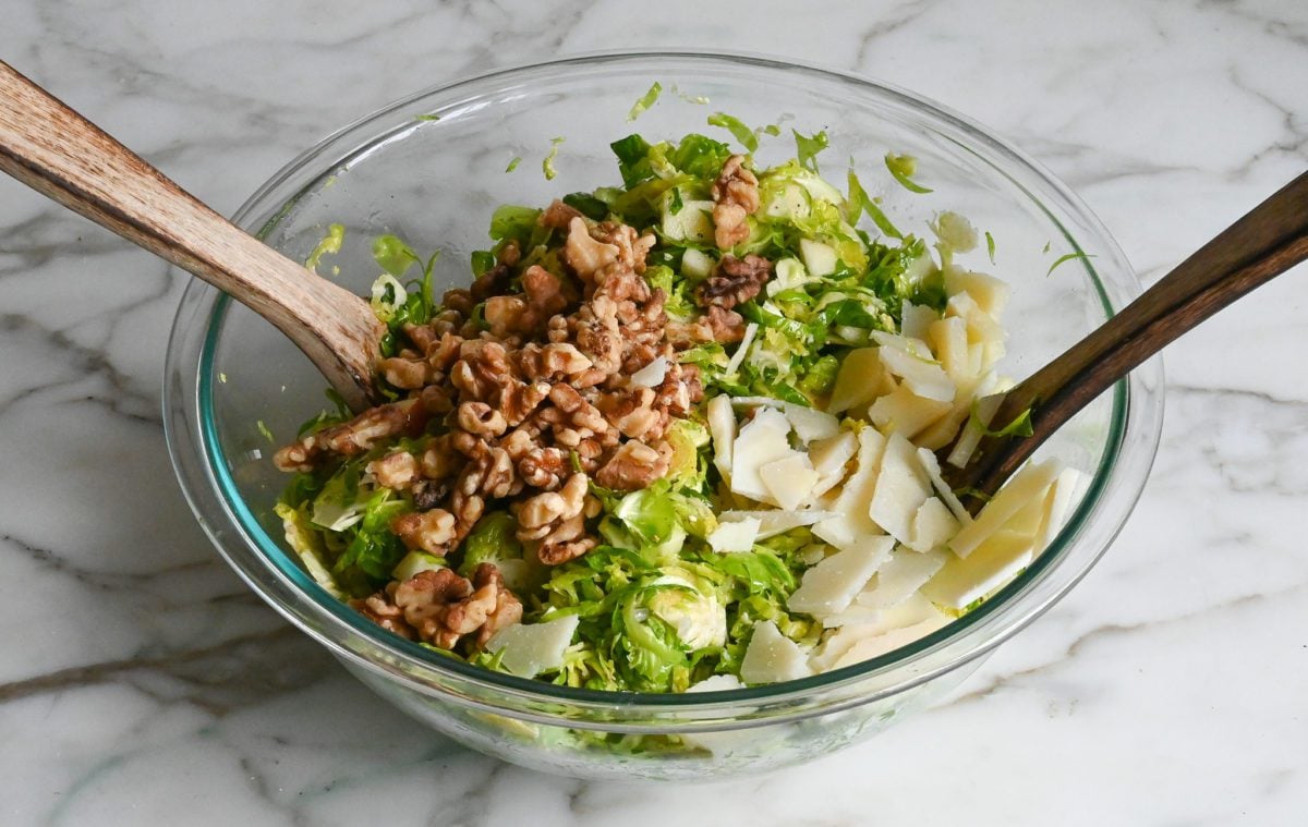 adding walnuts and cheese to salad