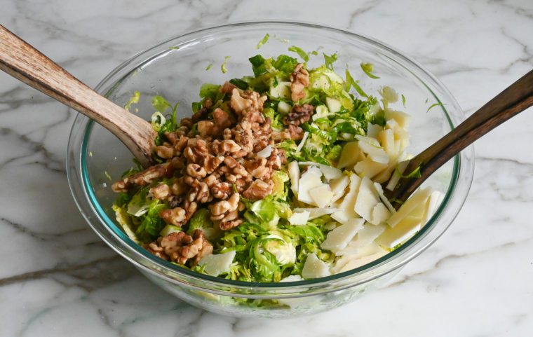 adding walnuts and cheese to salad
