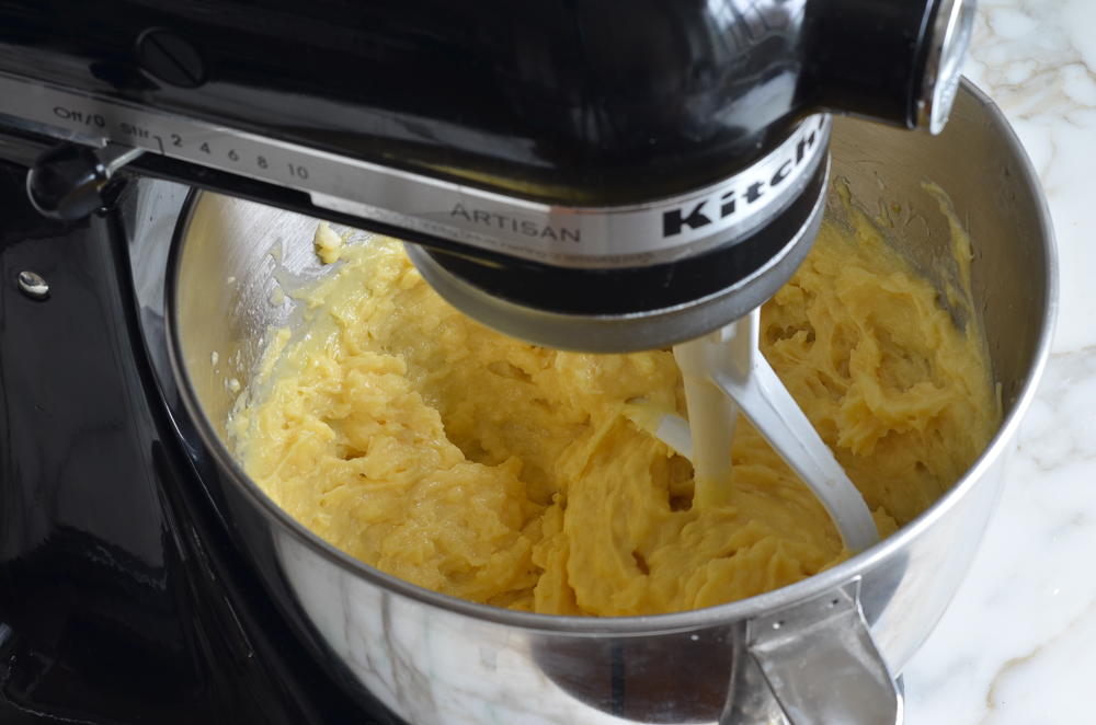 Gougeres dough in the bowl of a stand mixer.