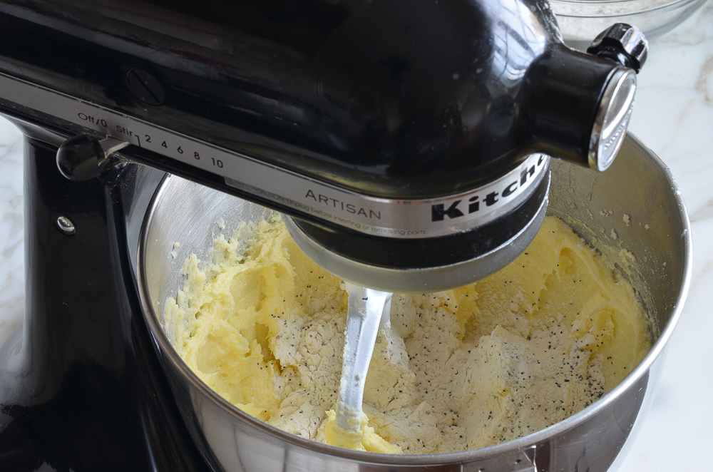 Dry ingredients in a stand mixer with a butter mixture.