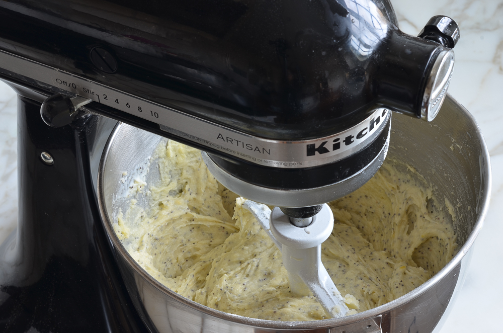 Lemon poppy seed cake batter in a stand mixer.