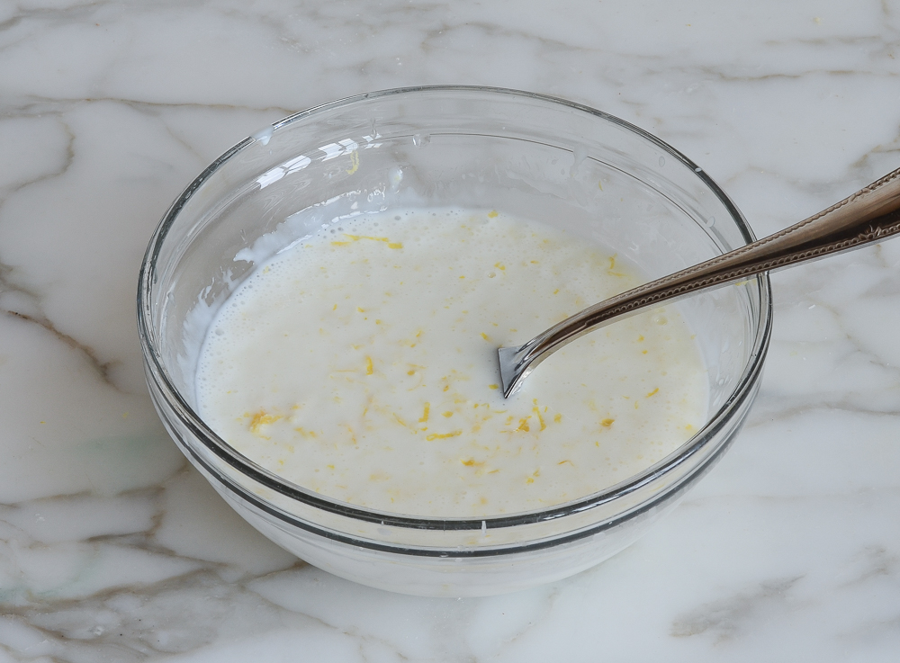 Fork in a bowl of buttermilk and lemon.