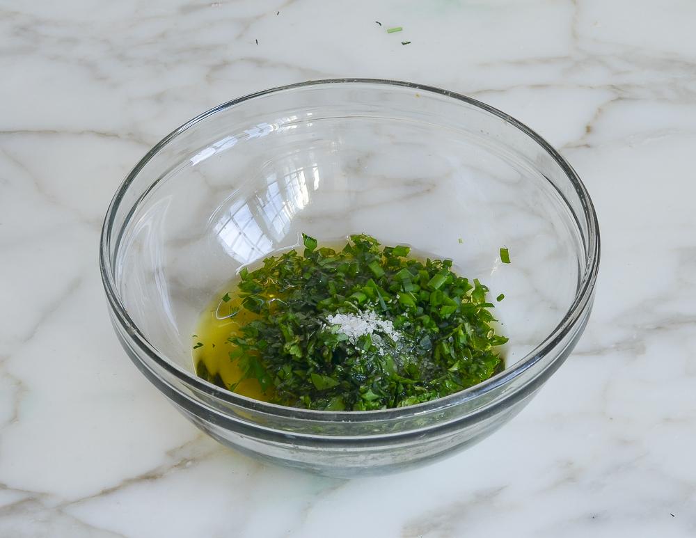Small bowl of herbs and oil.