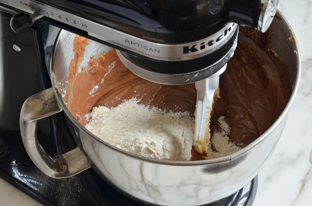 Flour being added to a chocolate mixture.