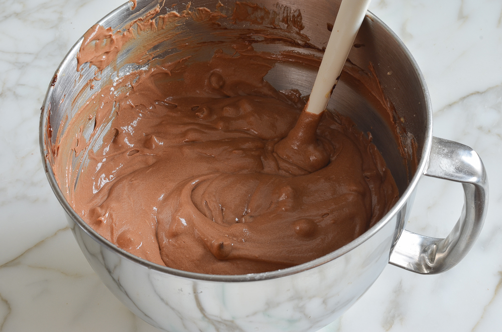Spatula in a bowl of chocolate cake batter.