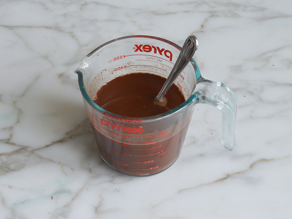 Measuring cup filled with a coffee mixture.