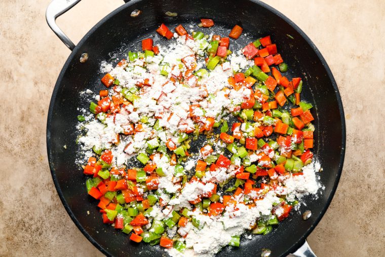adding the flour to the softened vegetables