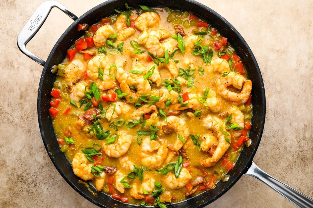 adding scallions to shrimp