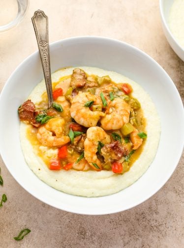 Spoon in a bowl of shrimp and grits.