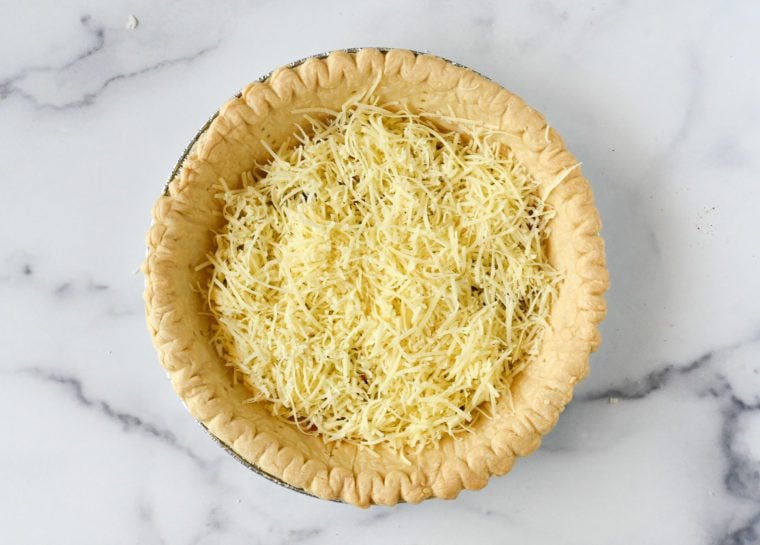 Shredded gruyere in a pie crust.