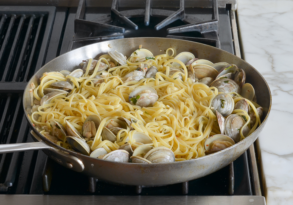 Pasta and clams in a skillet.