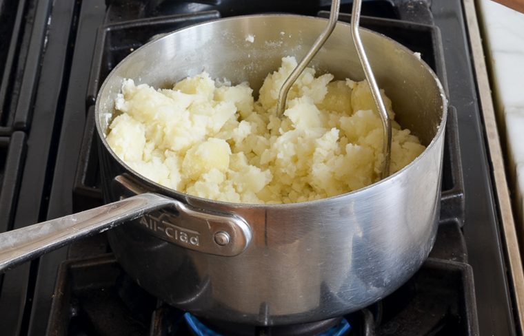 mashing and drying the potatoes