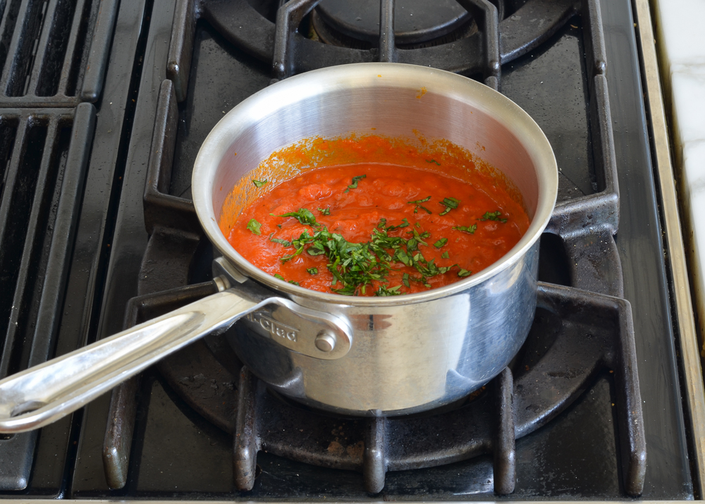 warming the sauce on the stovetop