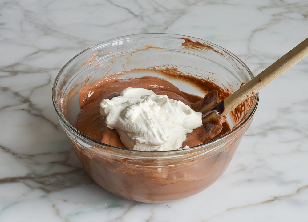 adding whipped cream to chocolate mixture