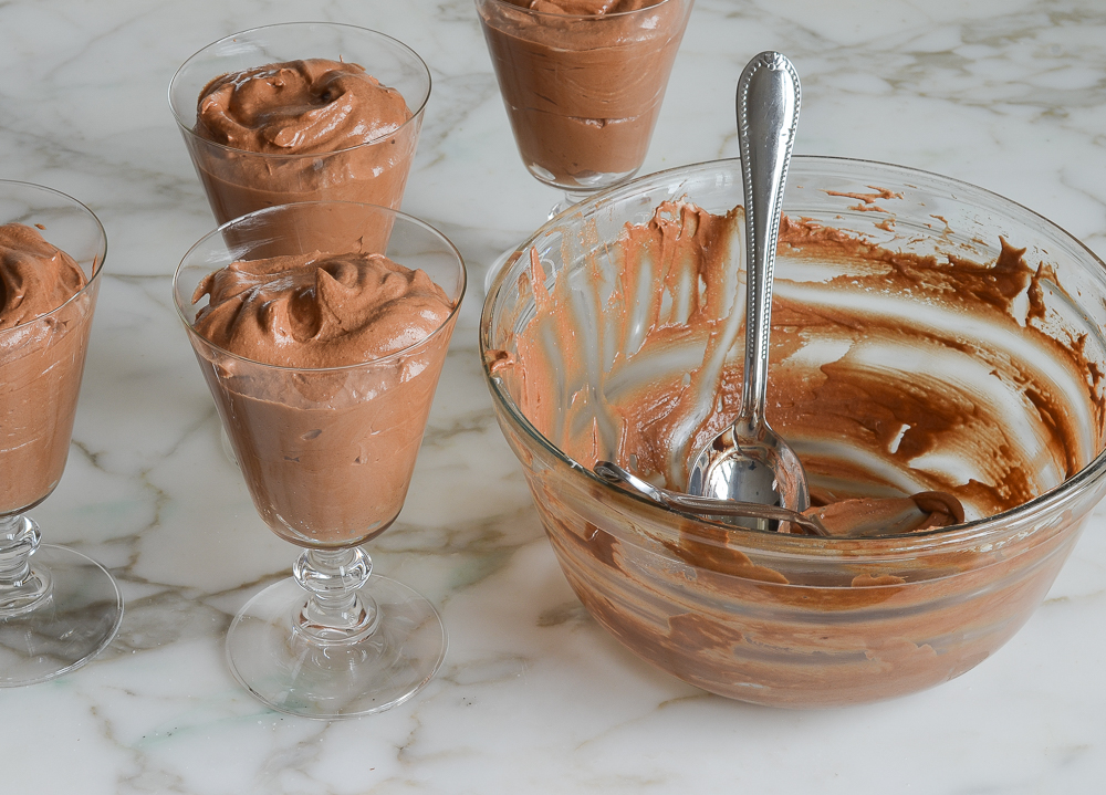 spooning the chocolate mousse into serving glasses