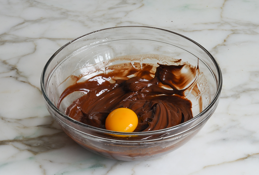 medium bowl with egg white/sugar mixture combined with melted chocolate