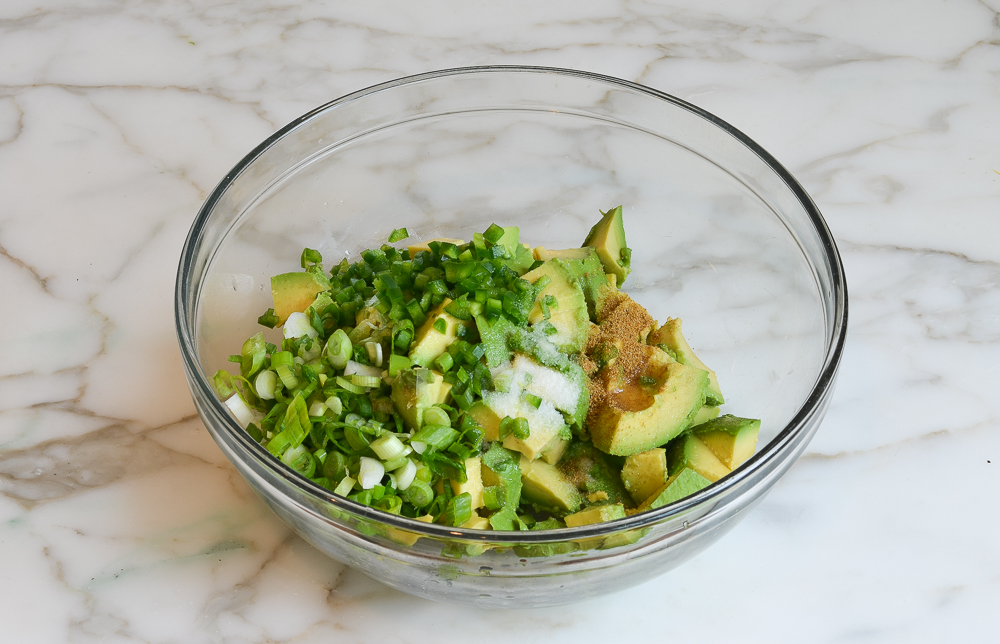 avocado, jalapeno, scallions and cumin added to mixing bowl