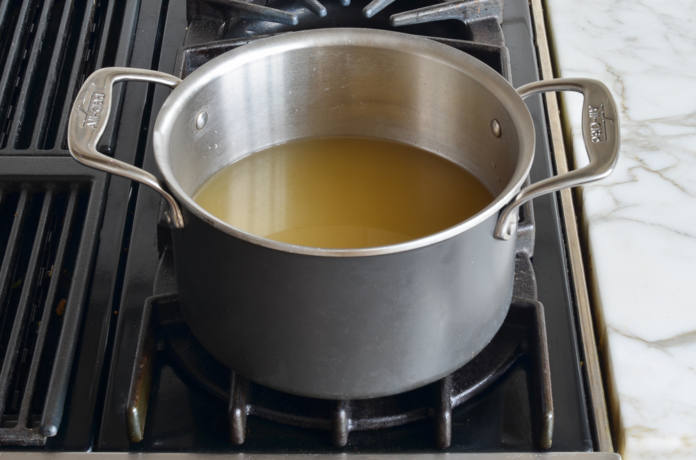 Sauce pan of simmering broth.