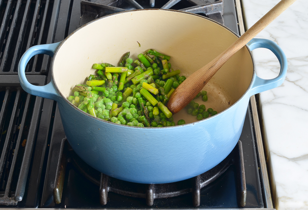 adding the peas to the asparagus