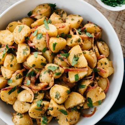 White bowl of German potato salad.