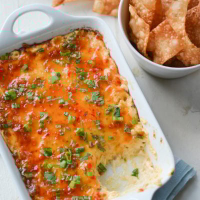 Dish of hot crab Rangoon dip with crispy wonton chips.